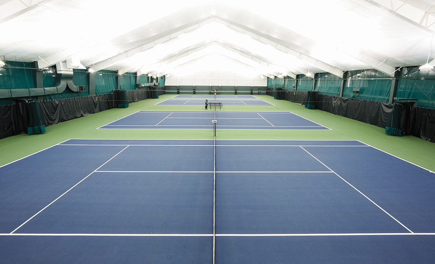 a tennis court with net and rackets