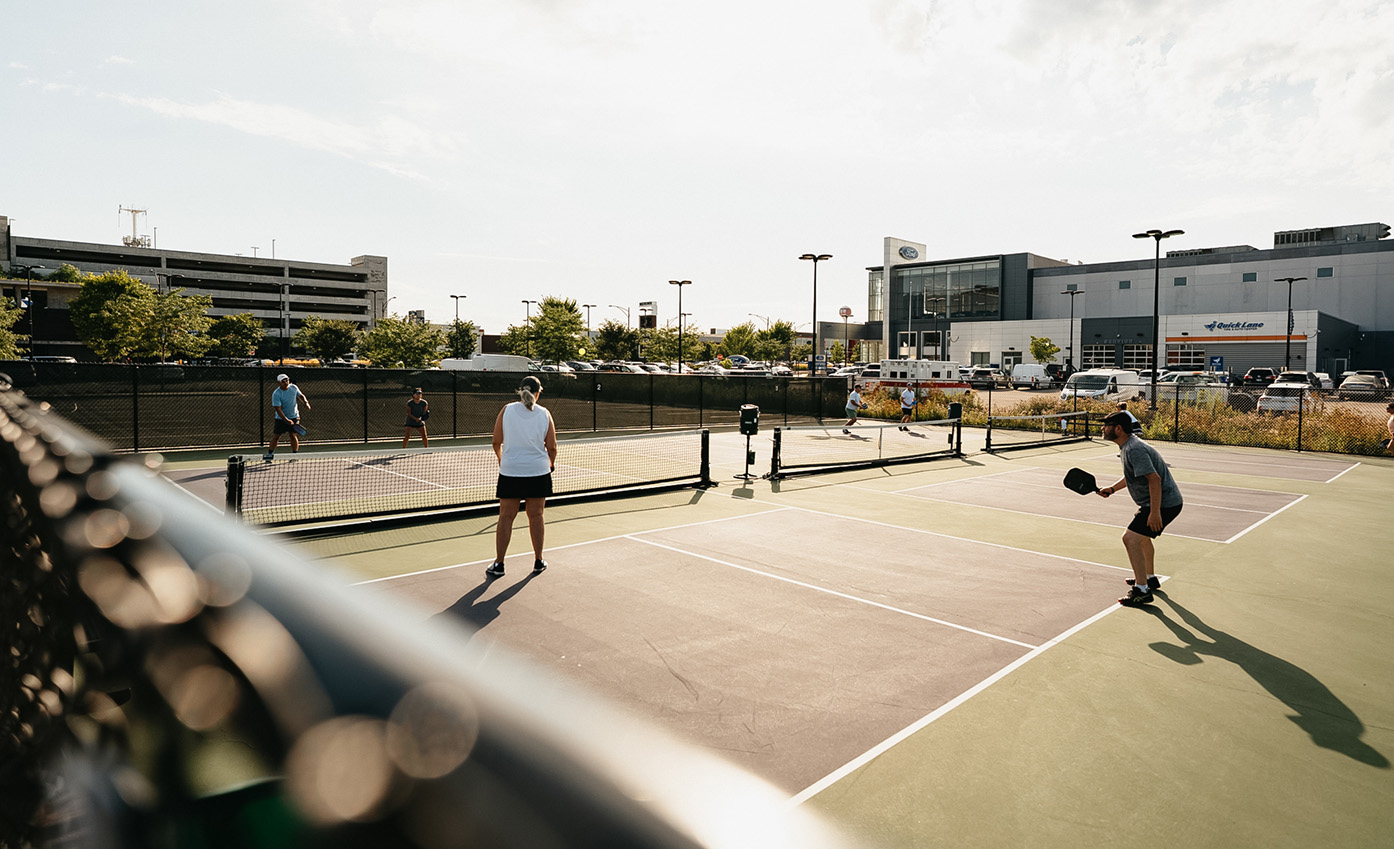 a group of people playing tennis