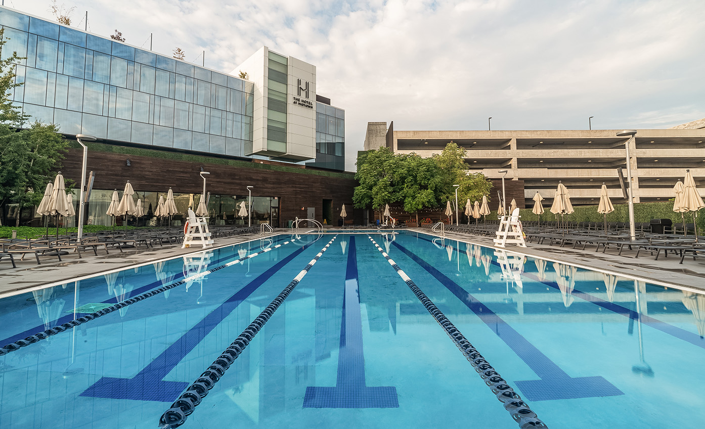 a swimming pool with a building in the background