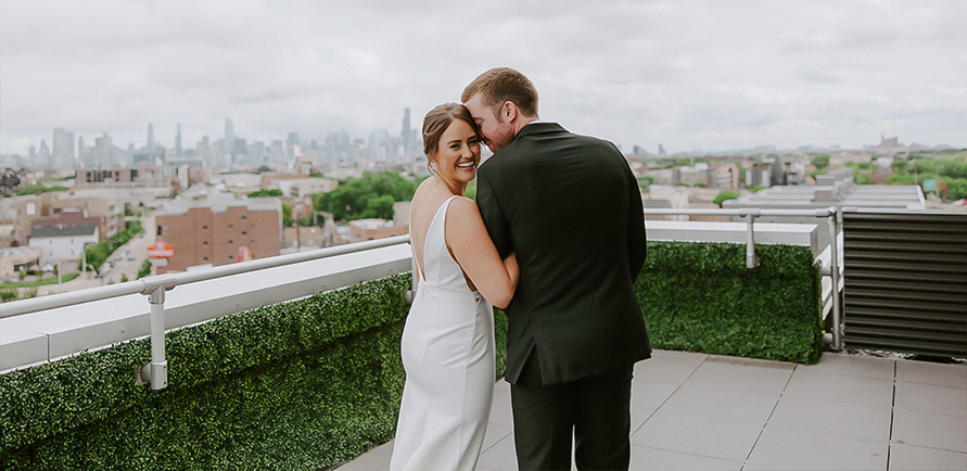 a man and woman hugging on a balcony