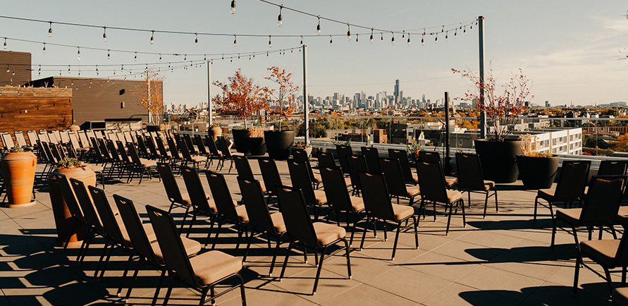 chairs on a patio with a city in the background