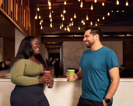 a man and woman holding drinks