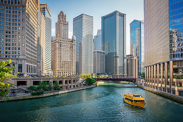 a river with a boat in it and Chicago River with tall buildings