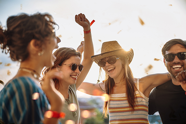a group of women laughing and throwing confetti