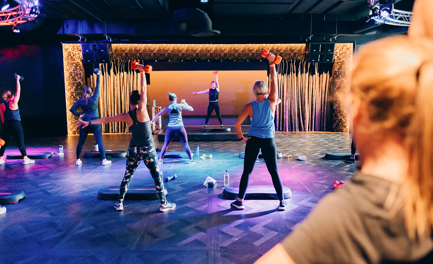 a group of people exercising on a stage