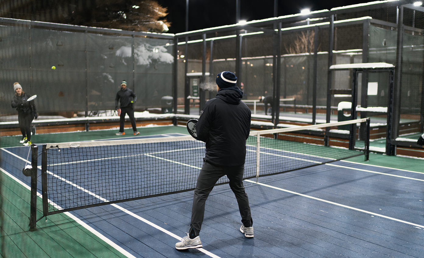 a man holding a tennis racket on a tennis court