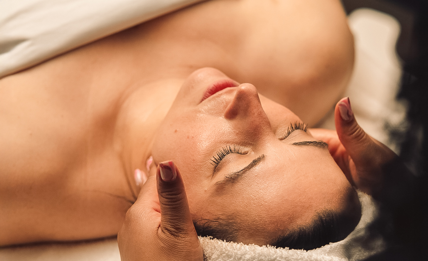 a woman lying down with her eyes closed
