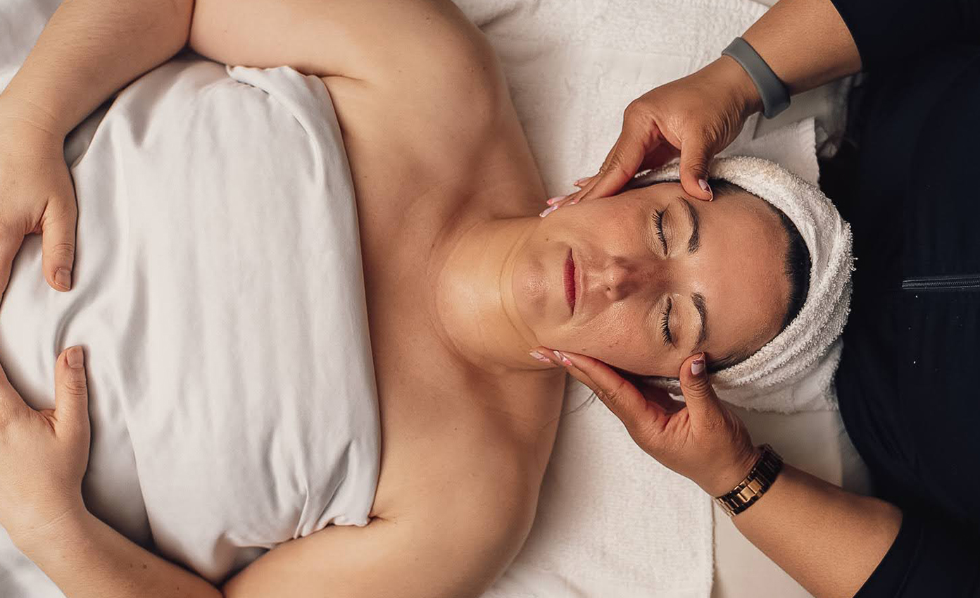 a woman lying down with a towel on her head
