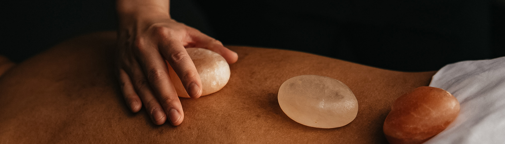a person's hand holding a rock on their back
