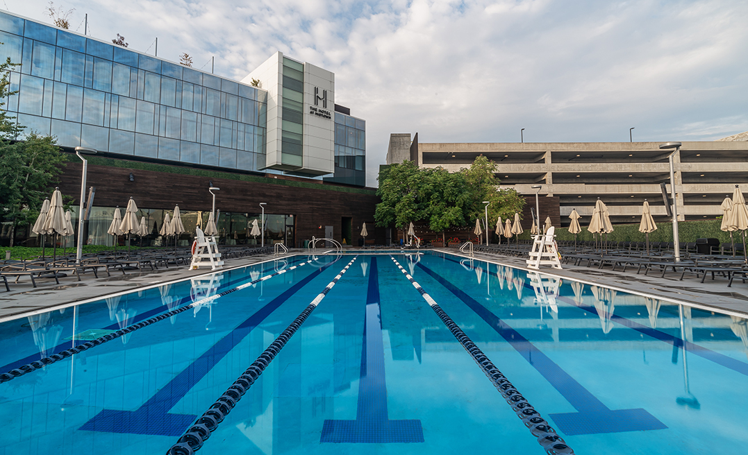 a swimming pool with a building in the background