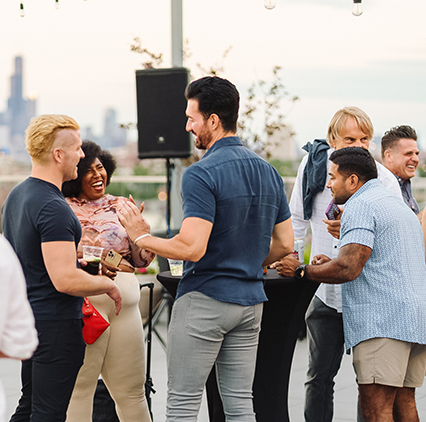 a group of people standing around a table