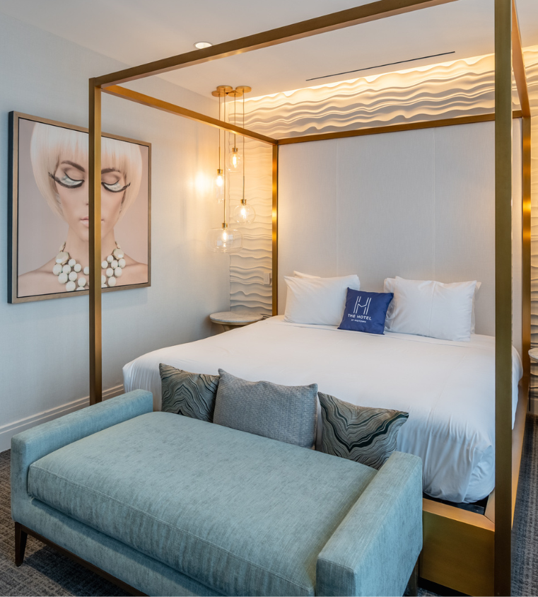 a bed with a couch and a picture of a woman