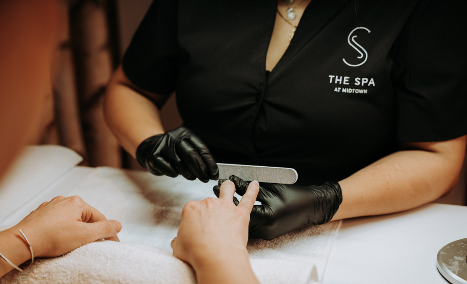 a woman receiving a manicure