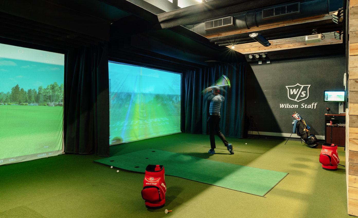 a person swinging a golf club