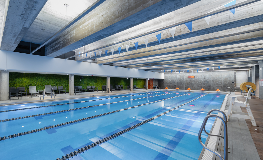 a swimming pool with chairs and a wall