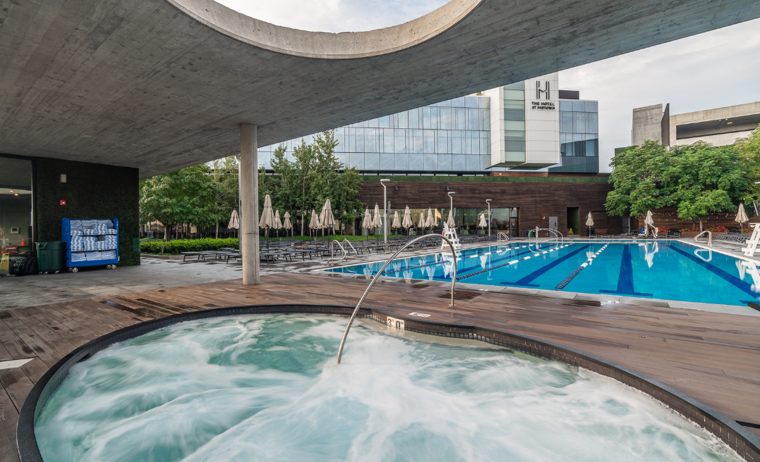 a pool with a large building and a large building
