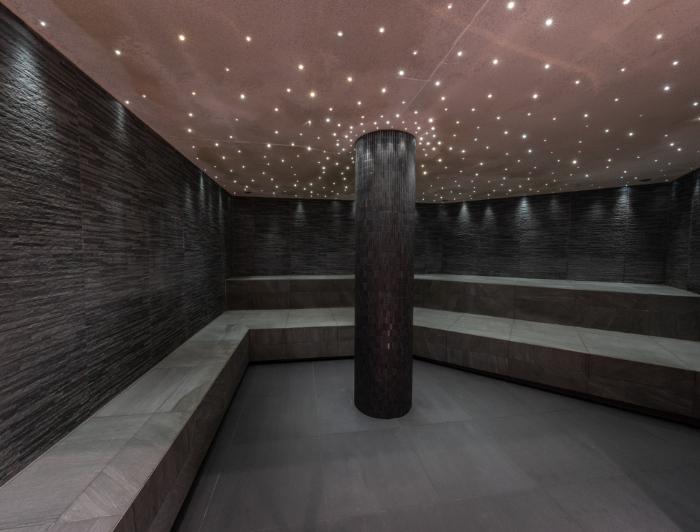 a room with a column and benches