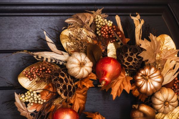 a wreath with pumpkins and leaves