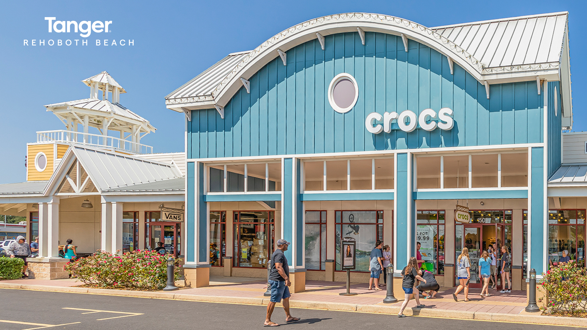 a group of people walking in front of a store