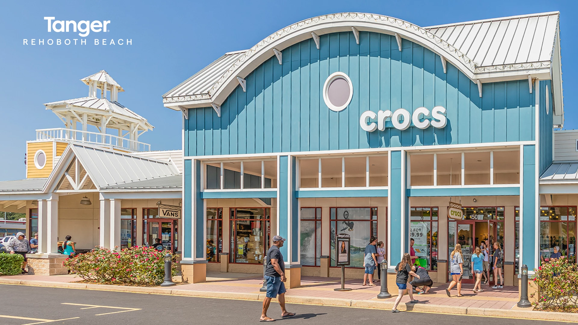 a group of people walking in front of a store