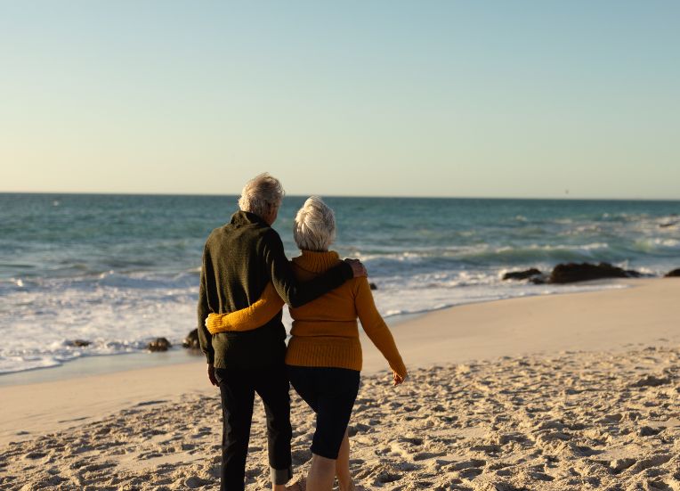 a man and woman standing on a beach