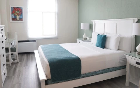 a bed with a lamp and a window