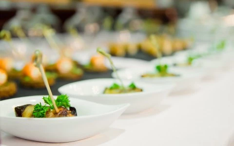 Snacks served in a white bowl for the guests of the wedding