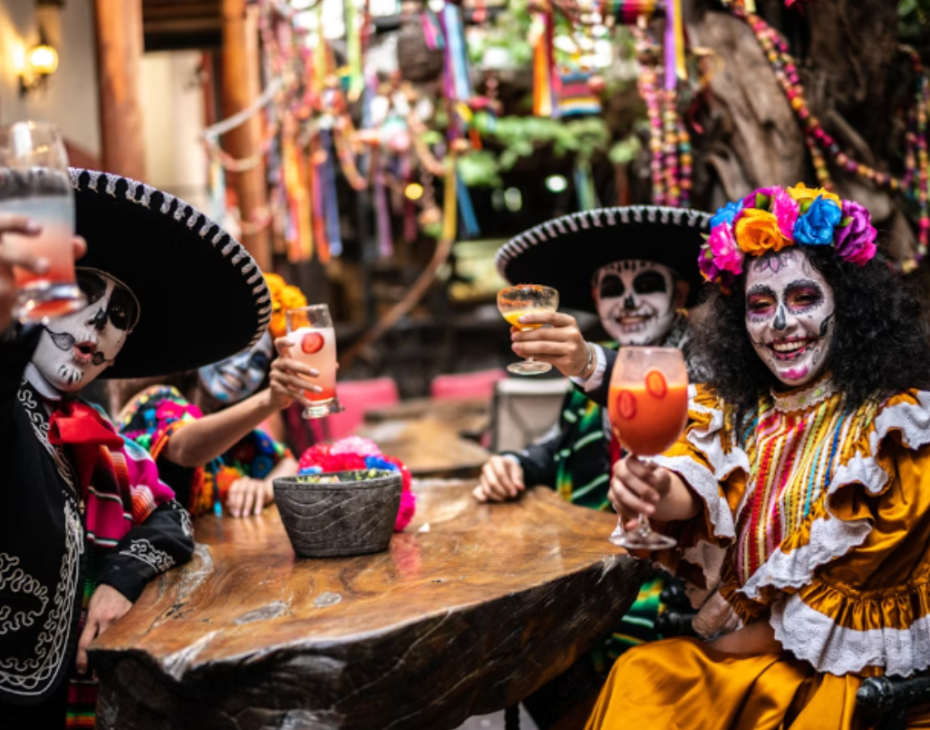 a group of people wearing face paint and holding drinks