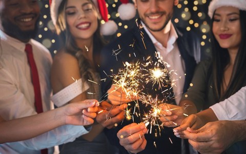 a group of people holding sparklers