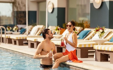 a man and woman sitting in a pool