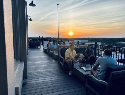 a group of people sitting on a deck