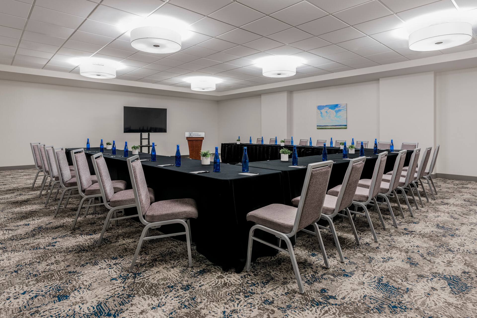 a room with a long table and chairs