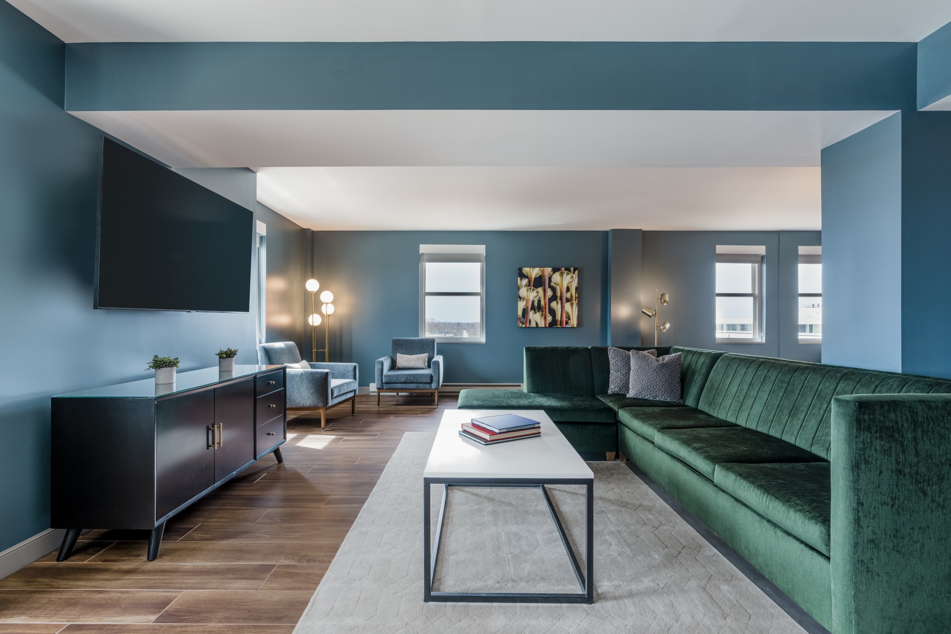 a living room with a green couch and a white coffee table