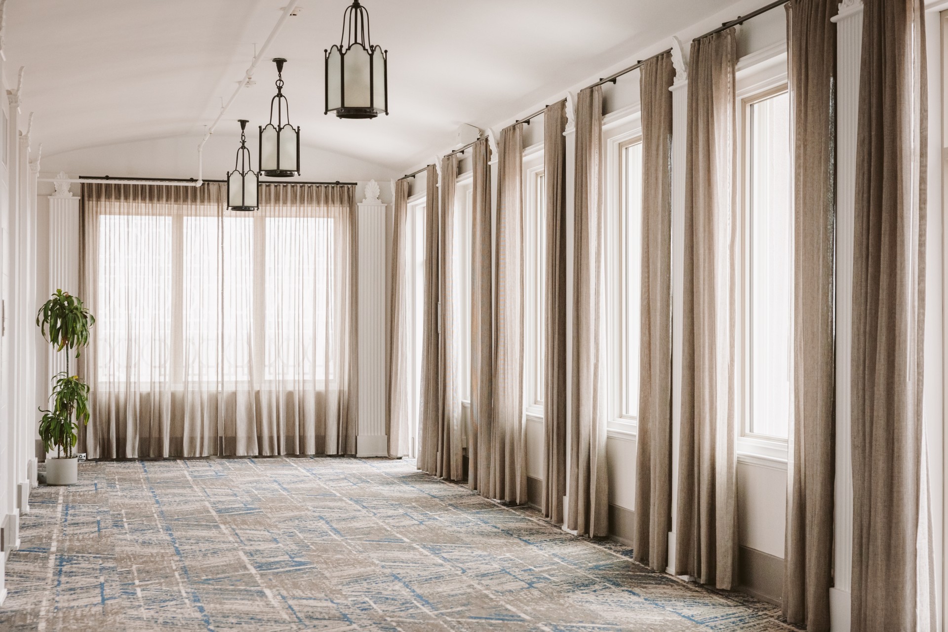 a room with curtains and windows