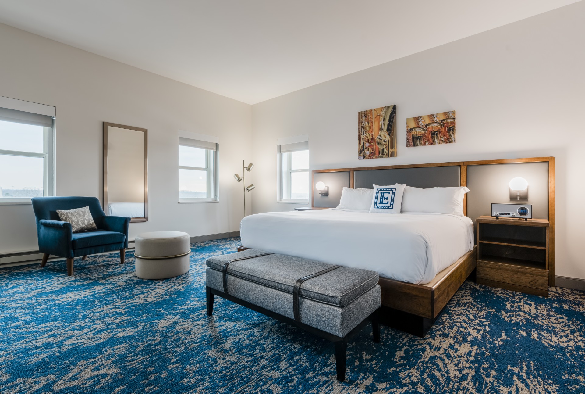 a room with a bed and a blue carpet