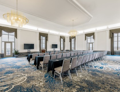 a room with a long table and chairs