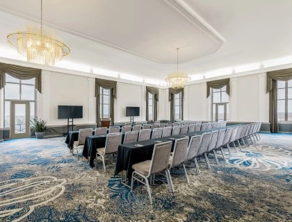 a room with a long table and chairs