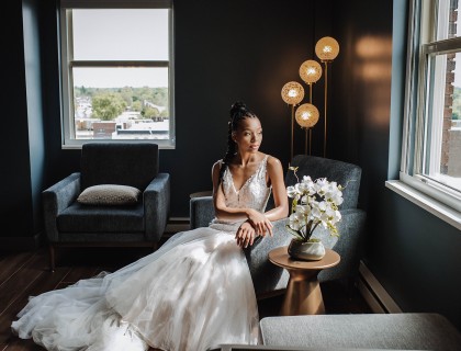 a woman in a white dress sitting in a chair