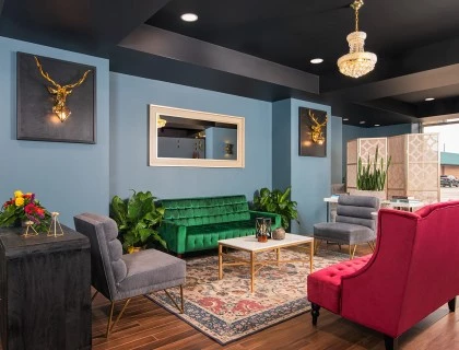 corner bar seating area with colorful chairs and chandeliers