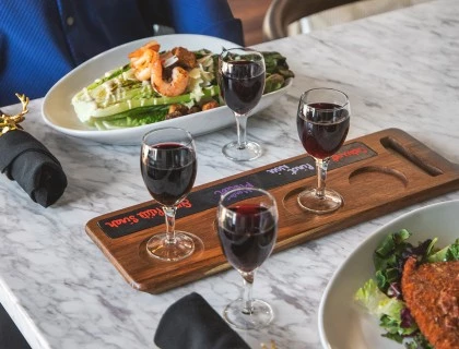 corner bar food on table with wine in glasses