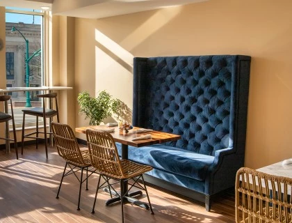 Blue couch seating with tables