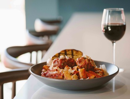 a plate of pasta and a glass of wine