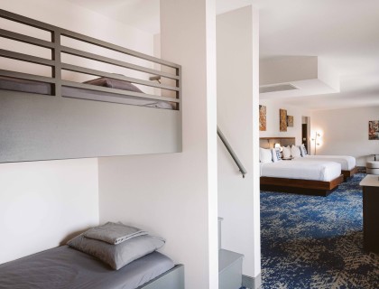 a room with two beds and a staircase