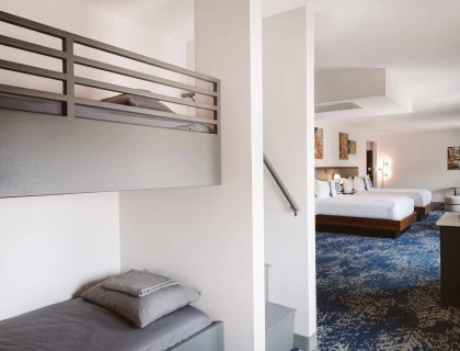 a room with two beds and a staircase
