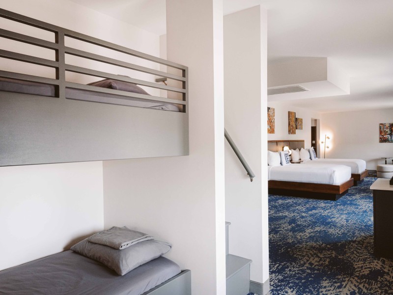 a room with two beds and a staircase