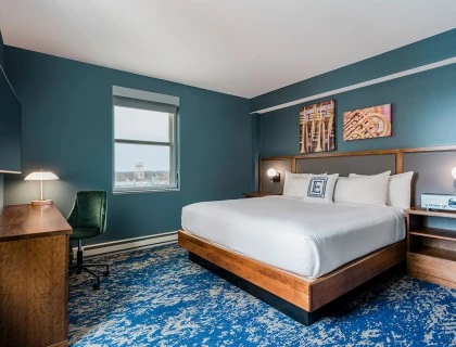 a bedroom with a bed and a desk