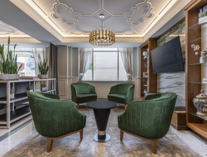 a room with green chairs and a table