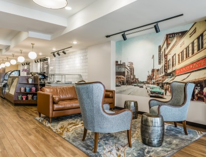 a room with chairs and a wall mural