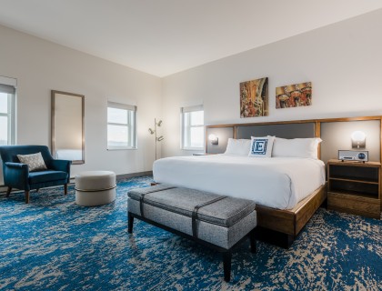 a room with a bed and a blue carpet