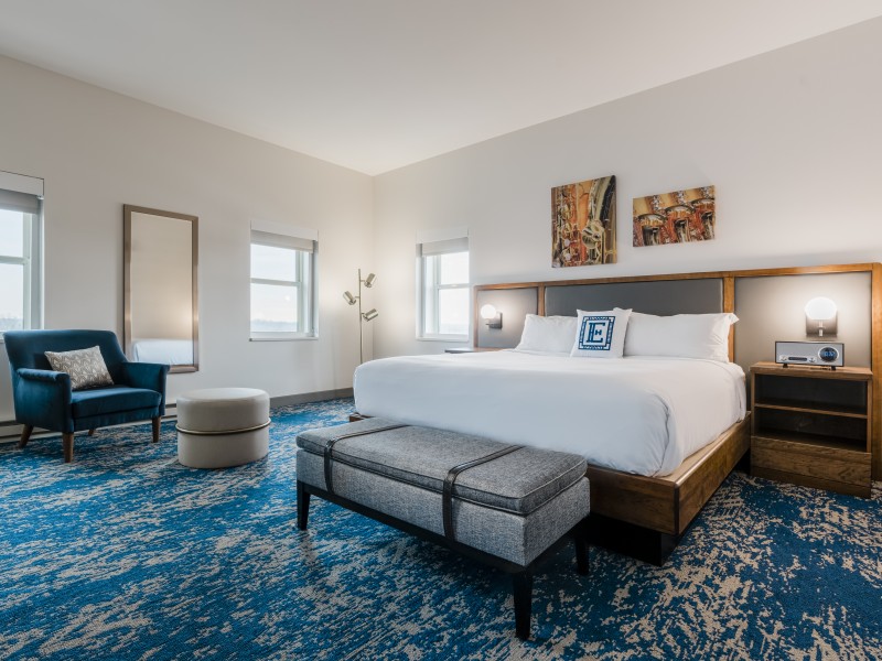 a room with a bed and a blue carpet